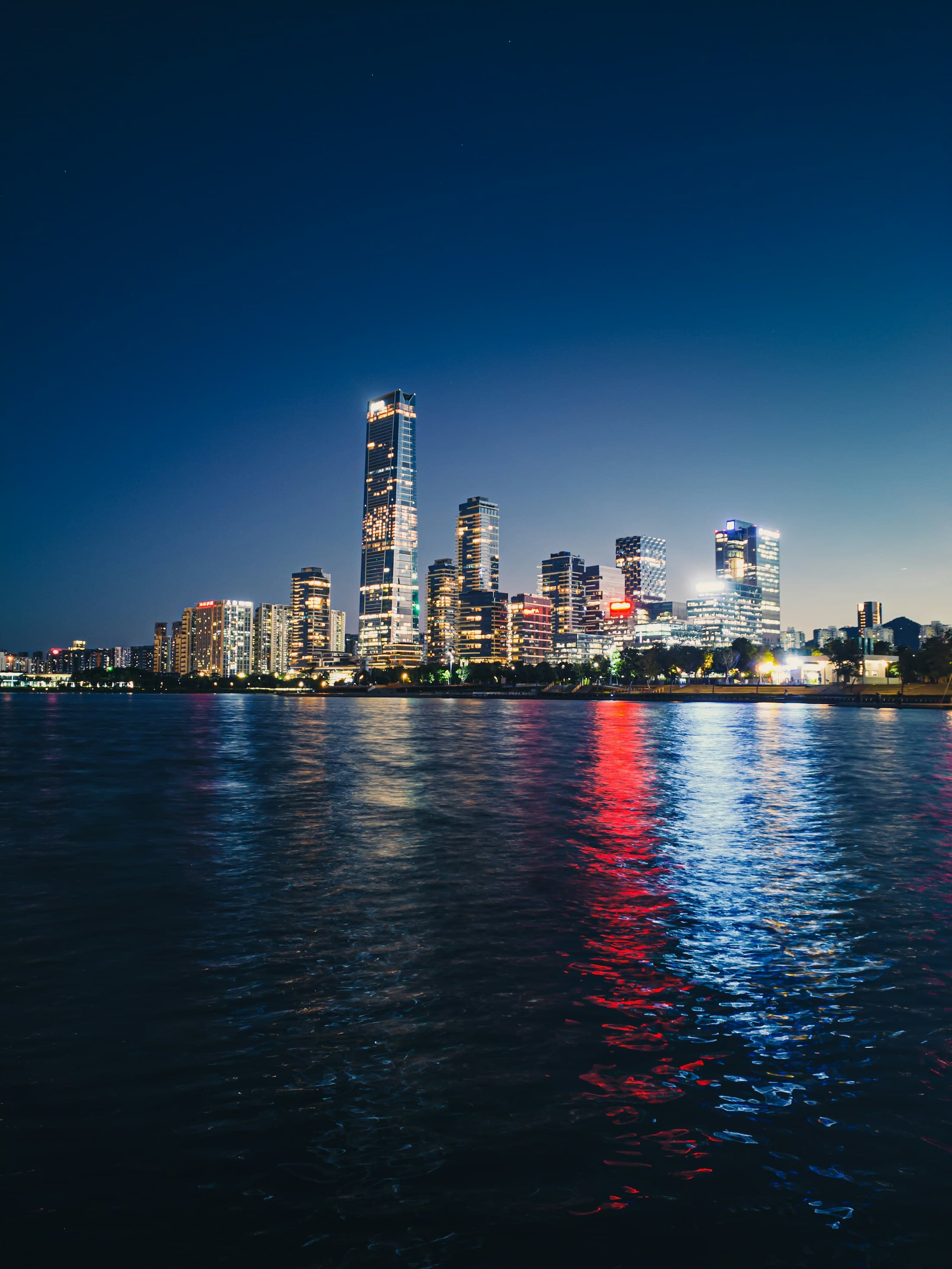 Shenzhen skyline reflected across the water after dark